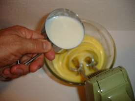 Slowly add 1 cup of the hot milk mixture to the egg yolks